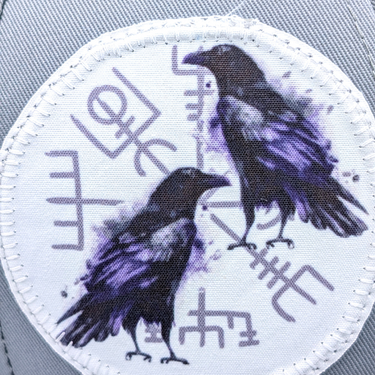 Up close view of patch Large White patch with two ravens in purple black in front of the Norse Compass Vegvisir.