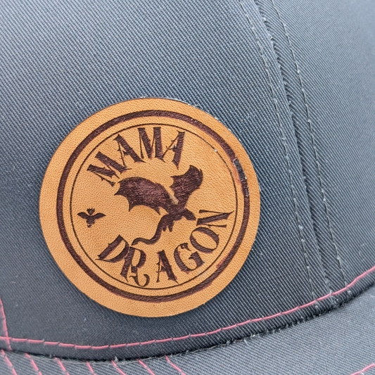Up close view of Montana Made Leather laser engraved patch. Inside a circle is a flying dragon, above the dragon is the word MAMA, and below is the text DRAGON. Gift for mom, mother's day gift