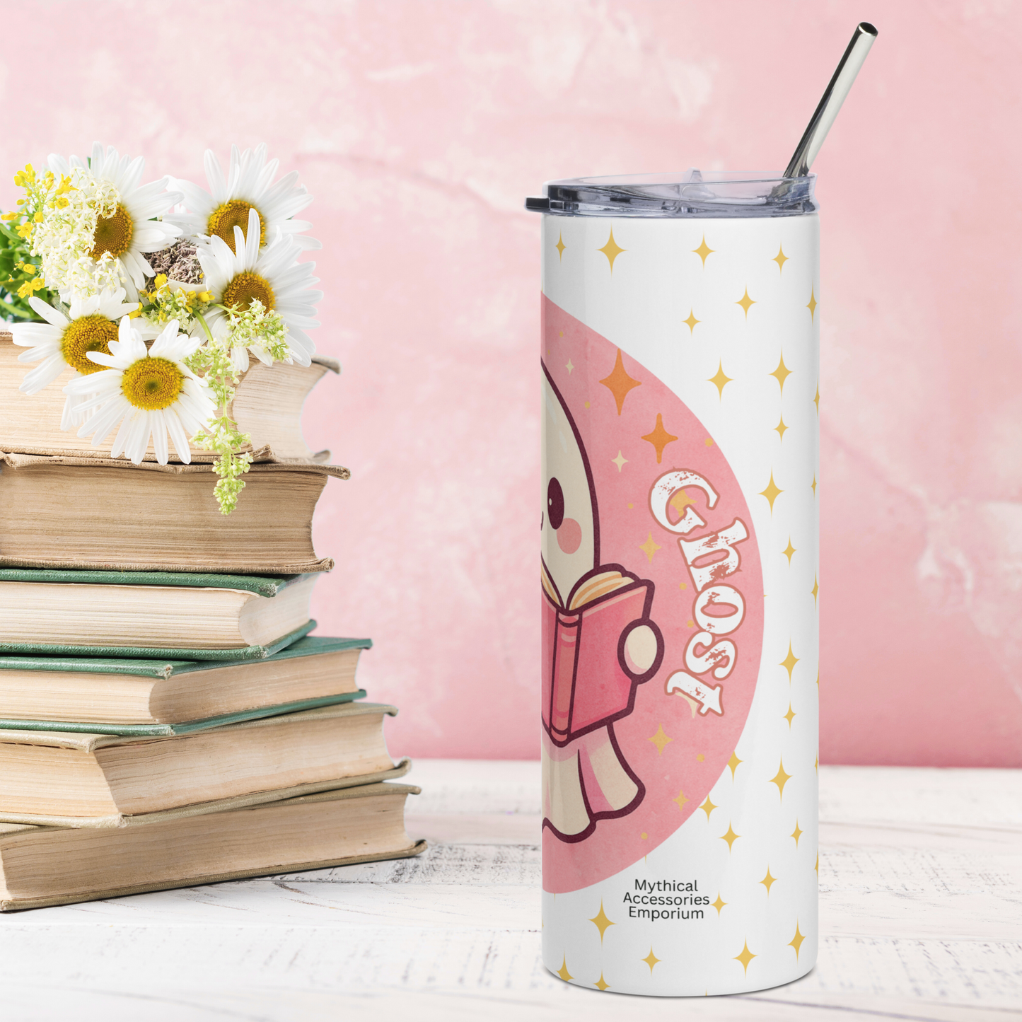 Right side view of Pink Coquette Book Ghost Stainless Steel Tumbler on White Background. Bubblegum pink circle with white ghost with pink shadows and rosy cheeks. The ghost is holding a pink book that is open and is reading. In white text to the right Ghost. There are yellow stars in the background on the white. BPA free plastic lid is leaning on the right side of the water bottle. Gift for Librarians and Teachers