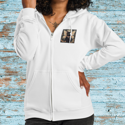 White Zip Up Hoodie on  female model with hood down and zipped. On the upper left side of the hoodie is a square graphic of a black fairy cat in a bed of light peach roses against the night sky with a full moon between the cat's wings. Mythical Accessories Emporium
