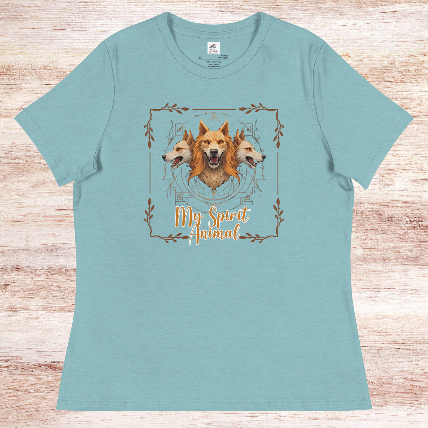 My Spirit Animal Cerberus Women's Graphic Tee, flat front View heather blue lagoon t shirt. A three headed guardian of the underworld in golden browns with jaws open to display canines. Below the hellhound is my spirit animal