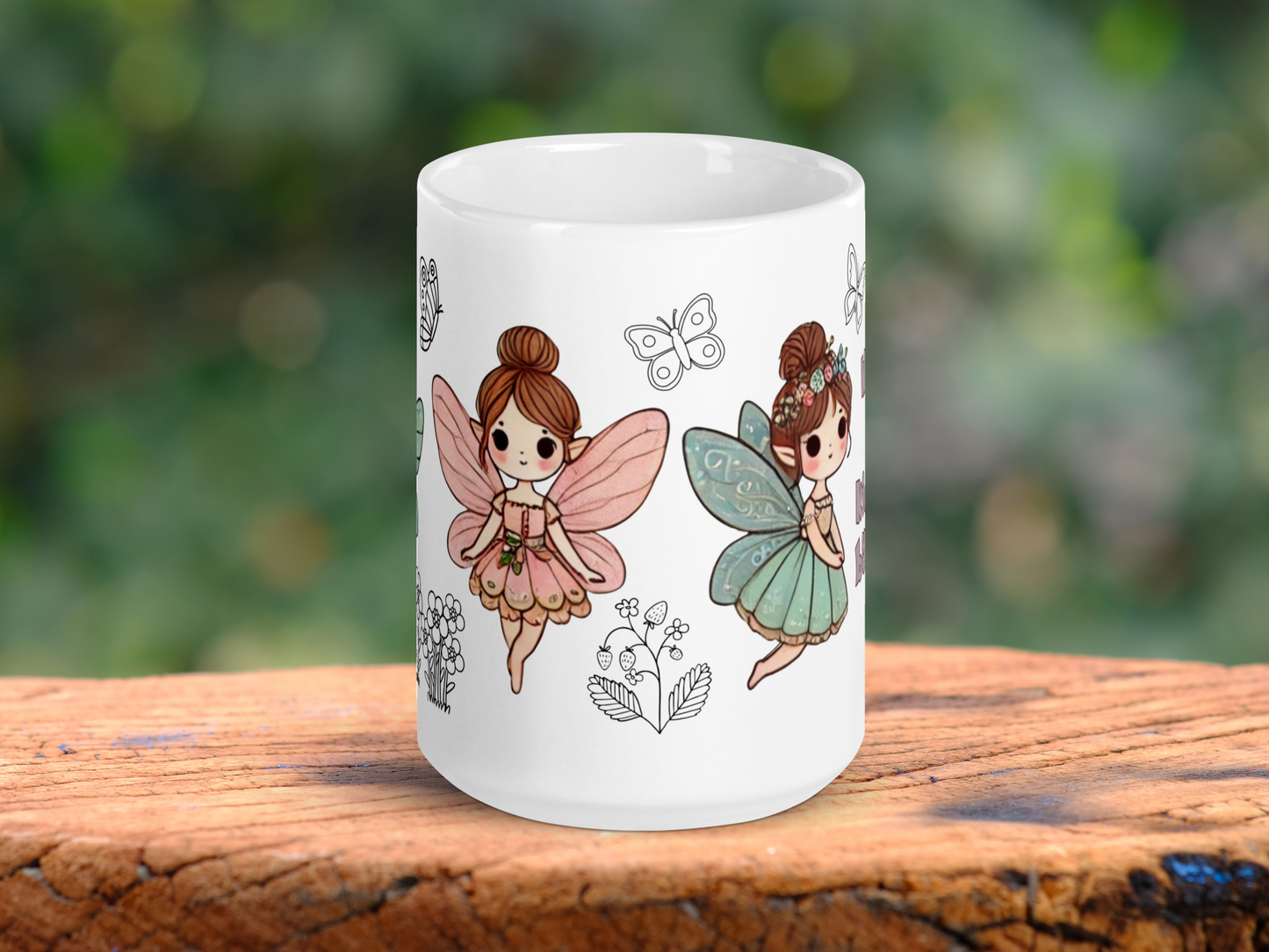 White Ceramic Fairy Mug handle to the back. On the left you can see a Fairy with outspread pink butterfly wings, a pink dress, pointed ears, and brunette hair in a bun. To the right is the flying fairy with blue butterfly wings, blue dress, pointed ears, brunette hair in a bun with flowers. Between the fairies is the outline of a butterfly and a strawberry plant. To the left you glimpse the outline of flowers and a butterfly. FairyCore Coffee Mug