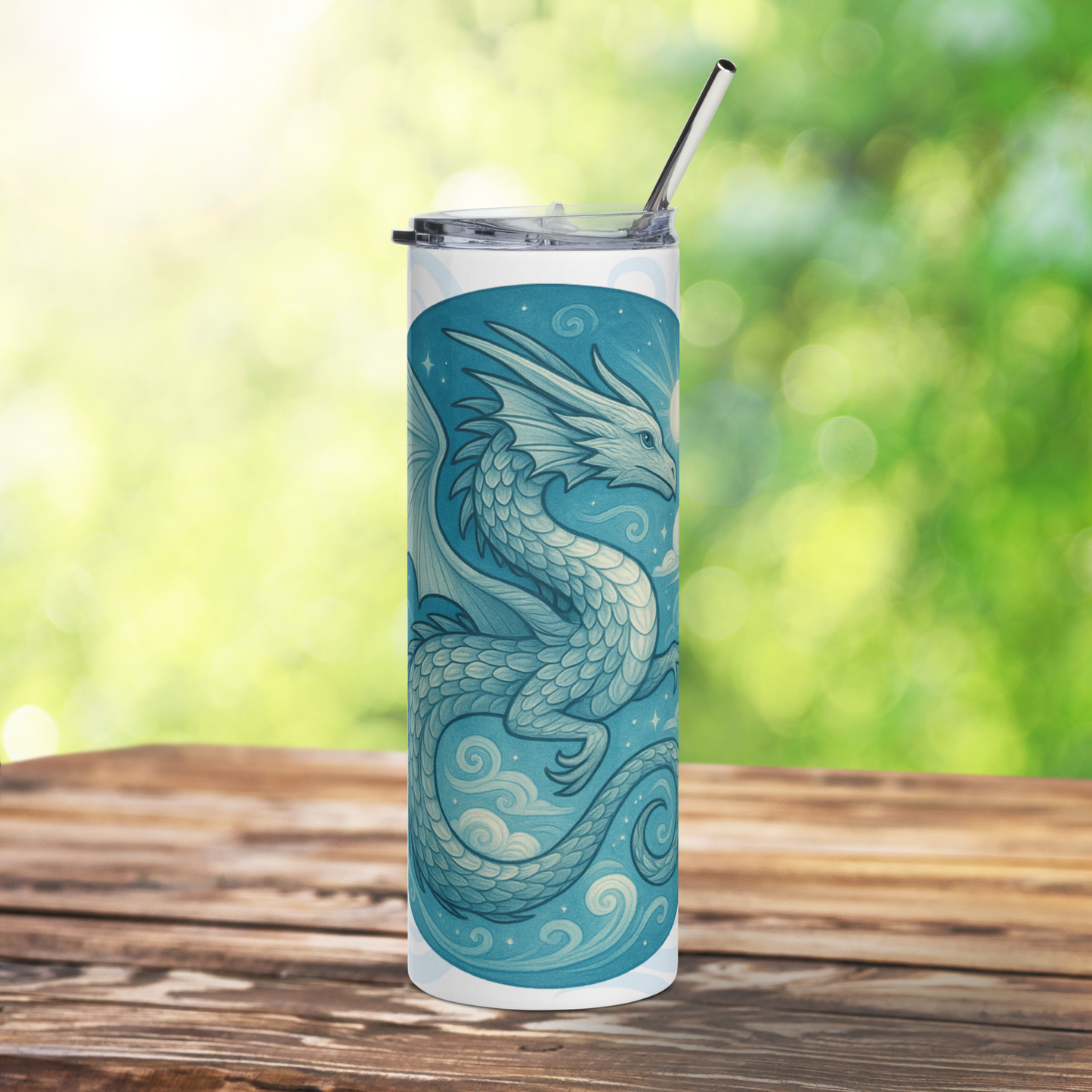 Front view of Elemental Air Dragon White Stainless Steel Tumbler. Blue Grey Dragon flying in a sun lit blue sky amongst clouds. Behind the circle graphic are air drifts in light blue grey. BPA free plastic lid is leaning against right side of tumbler. Fantasy Gift for Book Clubs and Booktok