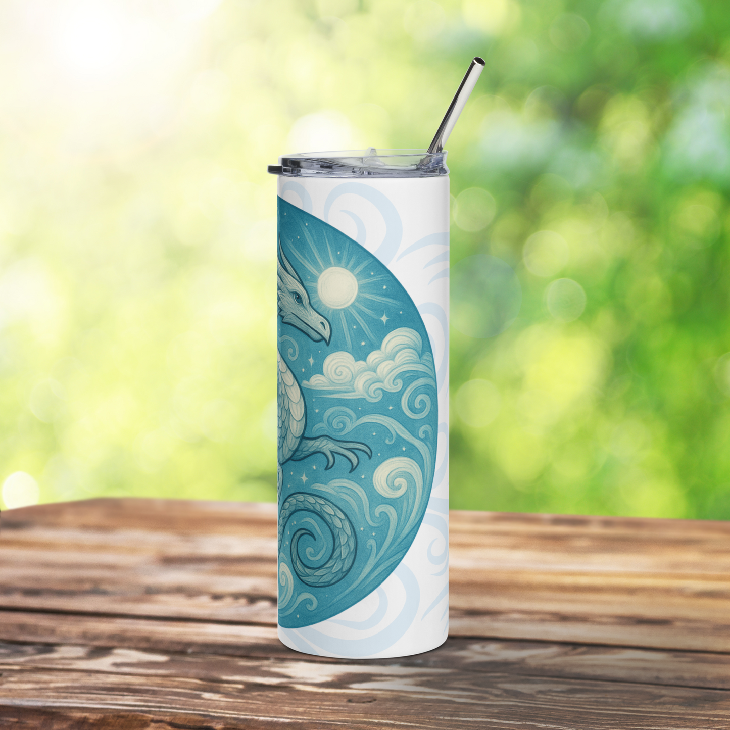Right side view of Elemental Air Dragon White Stainless Steel Tumbler. Blue Grey Dragon flying in a sun lit blue sky amongst clouds. Behind the circle graphic are air drifts in light blue grey. Bookish gift for travel accessories