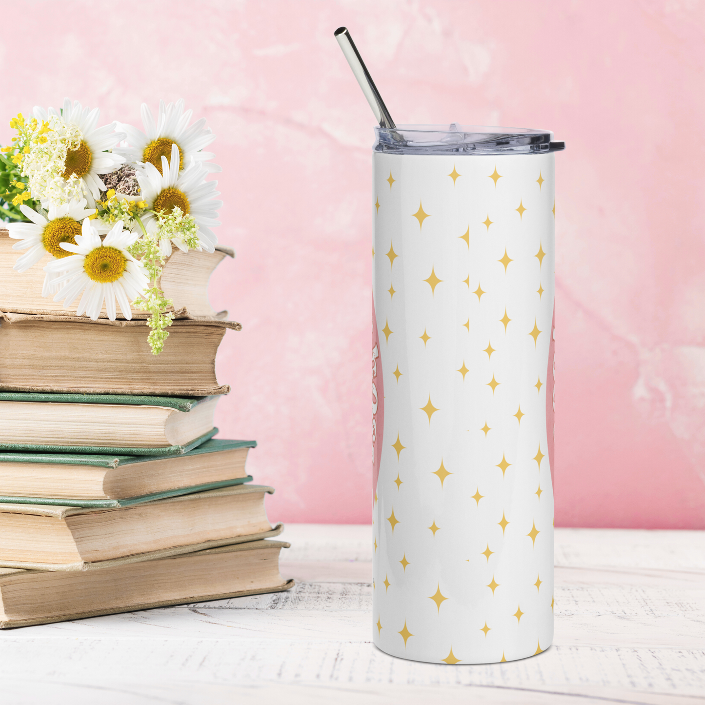 Back view of Pink Coquette Book Ghost Stainless Steel Tumbler on White Background. There are yellow stars in the background on the white. Lid is on the tumbler with the metal straw sticking up out of the top. Whimsical Ghost Reading Book