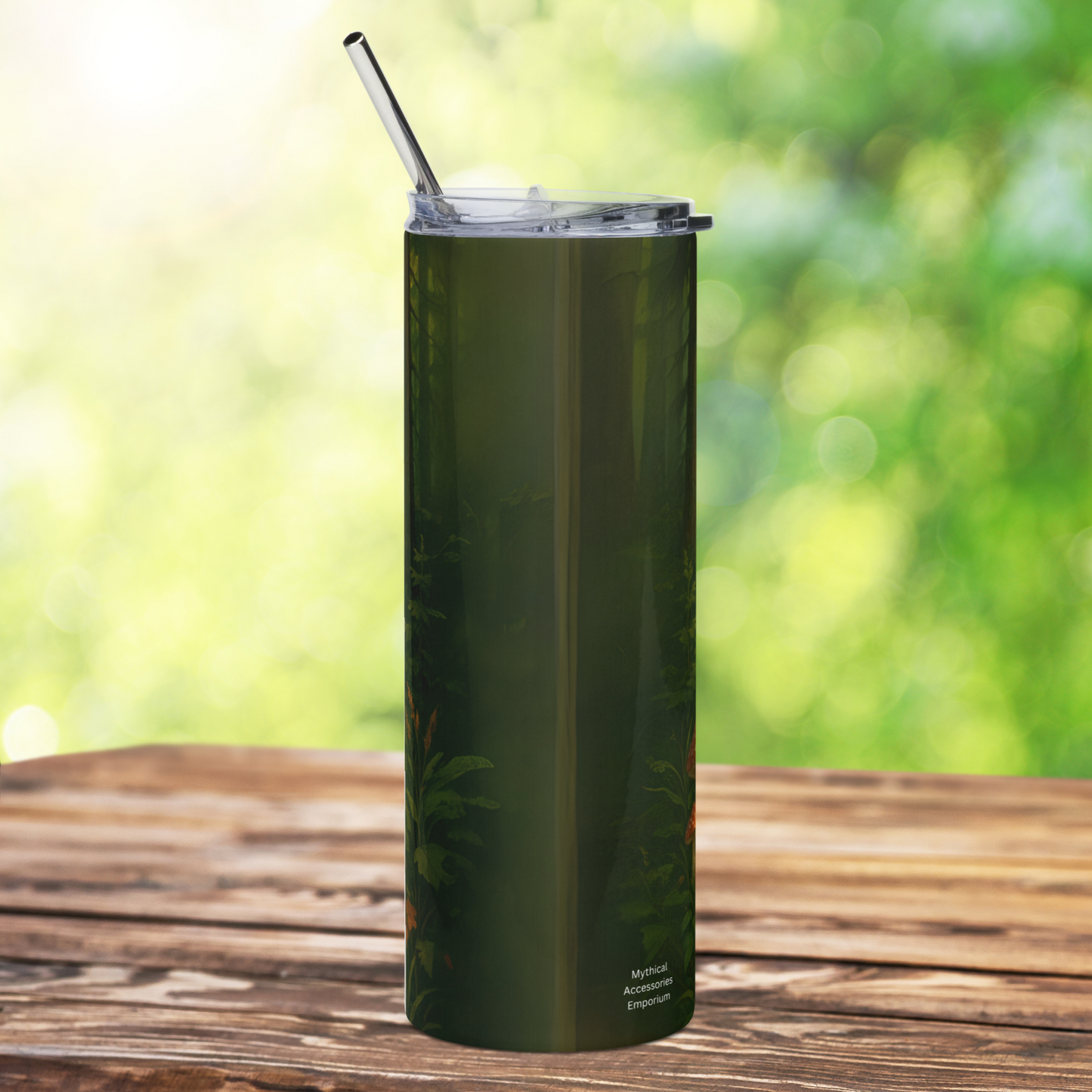 Yeti Bigfoot stainless steel 20oz tumbler with metal straw and lid, back view. Old growth trunks and foliage along with the brand name Mythical Accessories Emporium. Dark greens and browns. RV National Park Unique Gift