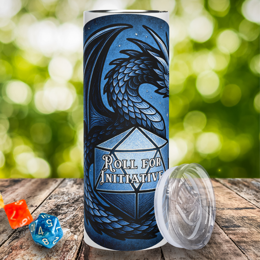 Blue Dragon D20 Stainless Steel Tumbler Front View with lid leaning against the right side. Here you see the front view of the blue graphic. The dragons neck, right side of wing, and tail are visible. The trail is wrapped around a blue D20 with white text. The text says, "Roll for Initiative". Fantasy Travel Tumbler