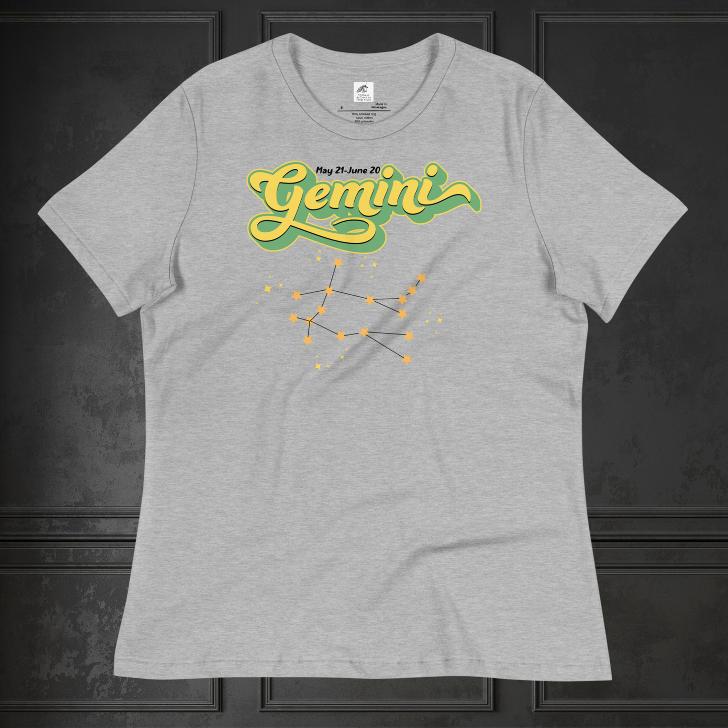 Front view of flat lay heather athletic grey women's Gemini Tee on a black surface. This Astrology T-Shirt has the word Gemini in large lemon yellow script shadowed in bright green for a 3-D effect. Above this it Says May 21-June 20. Under Gemini is the star constellation with yellow stars connected by a black line and yellow smaller stars surrounding this. The perfect May or June Birthday Gift for Her or yourself.