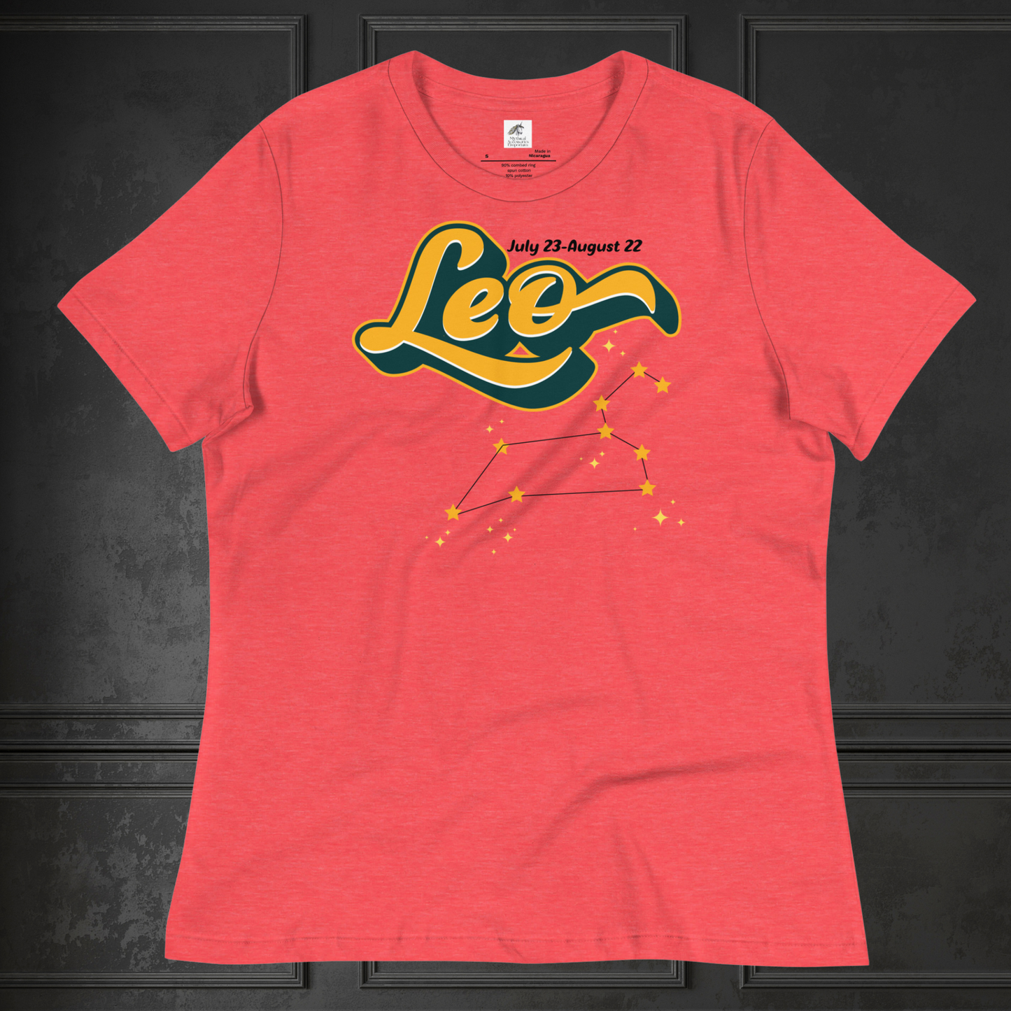 Front view of flat lay Heather Red women's Leo Tee. This astrology Leo T-Shirt has the word Leo in large yellow script shadowed in deep green for a 3-D effect. Above this it Says July 23-August 22. Under Cancer is the zodiac star constellation with yellow stars connected by a black line and lighter yellow smaller stars surrounding this. The perfect July or August Birthday Gift for Her or yourself.