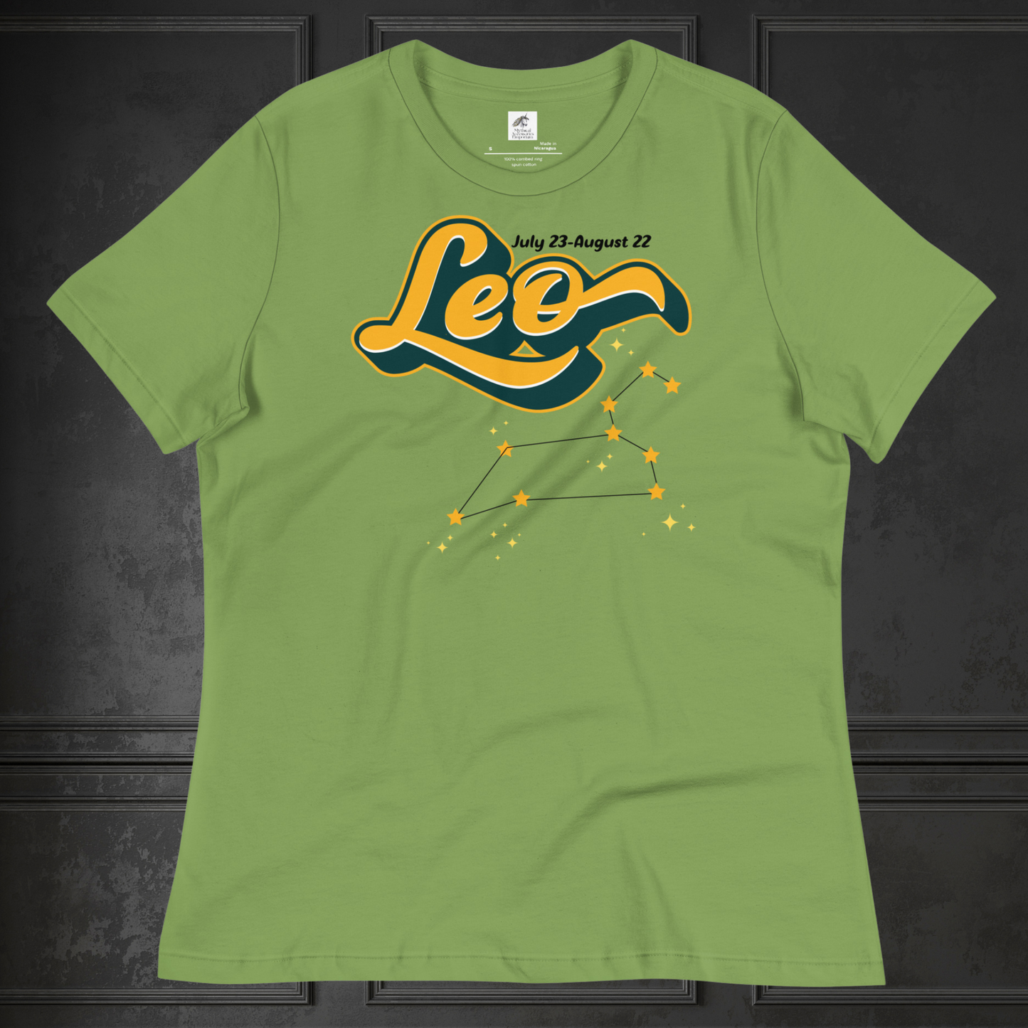 Front view of flat lay leaf green women's Leo Tee. This astrology Leo T-Shirt has the word Leo in large yellow script shadowed in deep green for a 3-D effect. Above this it Says July 23-August 22. Under Cancer is the zodiac star constellation with yellow stars connected by a black line and lighter yellow smaller stars surrounding this. The perfect July or August Birthday Gift for Her or yourself.