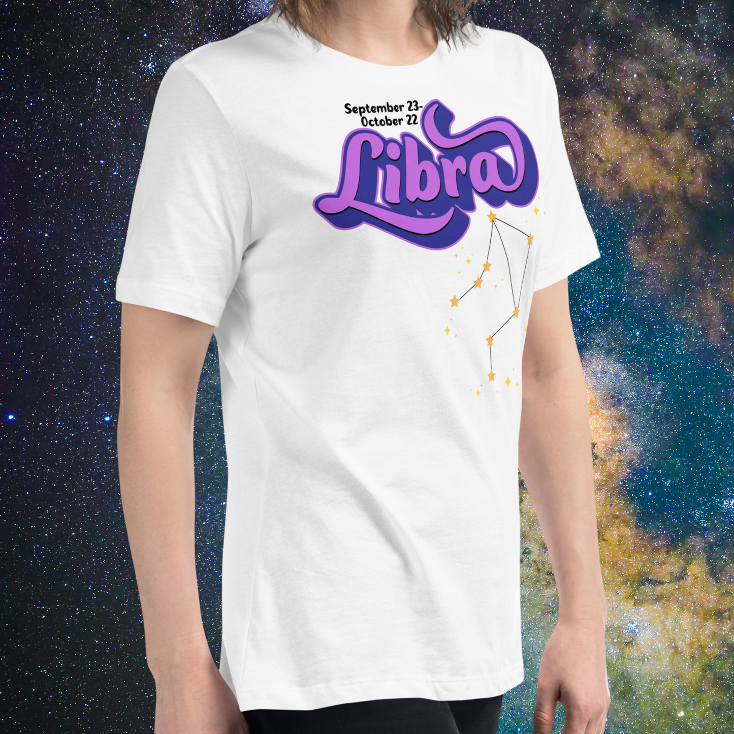 Right side view of model wearing white women's Libra Tee. This astrology Libra T-Shirt has the word Libra in large purple script shadowed in deep blue for a 3-D effect. Below this it Says September 23-October 22. Under Libra is the zodiac star constellation with yellow stars connected by a black line and lighter yellow smaller stars surrounding this. The perfect October or September Birthday Gift for Her or yourself.