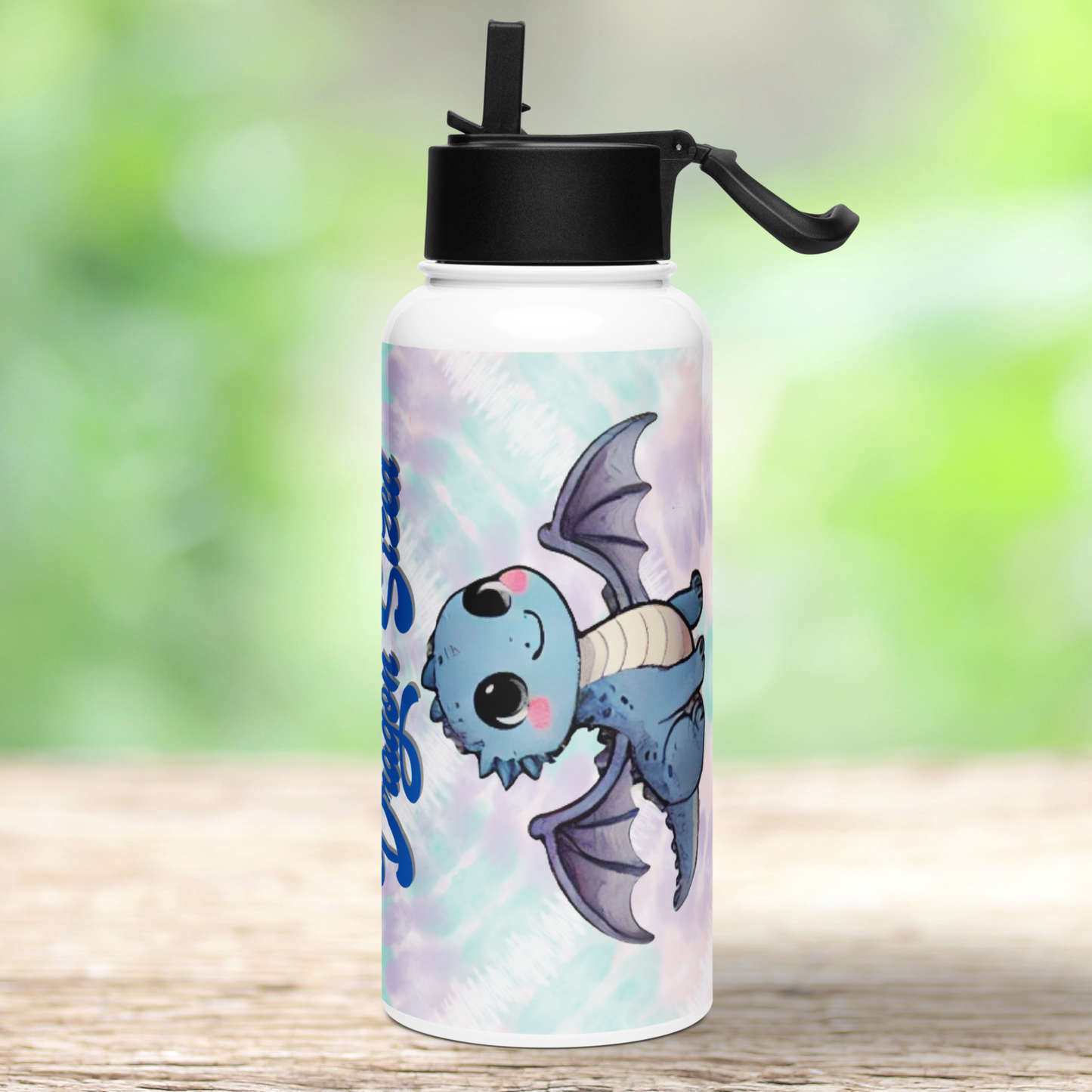 Right side view of stainless steel bottle dragon tumbler. Black lid has a flip up straw that is standing up and the handle is lifted on the right side. You can see a baby blue dragon with large eyes, rosy checks and extended wings. Background i blue and purple tie dye.