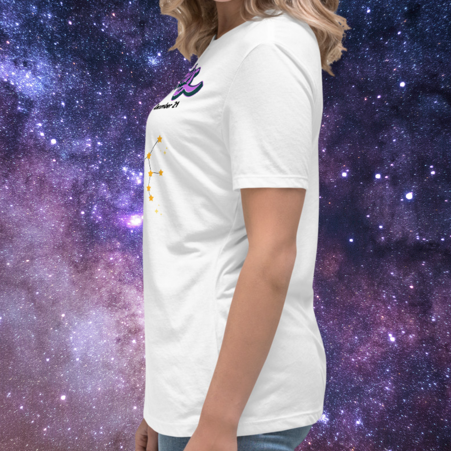 Left side view of model wearing white women's Sagittarius Tee. This astrology T-Shirt has the word Sagittarius in large purple script shadowed in black for a 3-D effect. Below this it Says November 22-December 21. Under Sagittarius is the zodiac star constellation with yellow stars connected by a black line and lighter yellow smaller stars surrounding this. You can see the side seam for the shirt. The perfect November or December Birthday Gift for her or yourself.