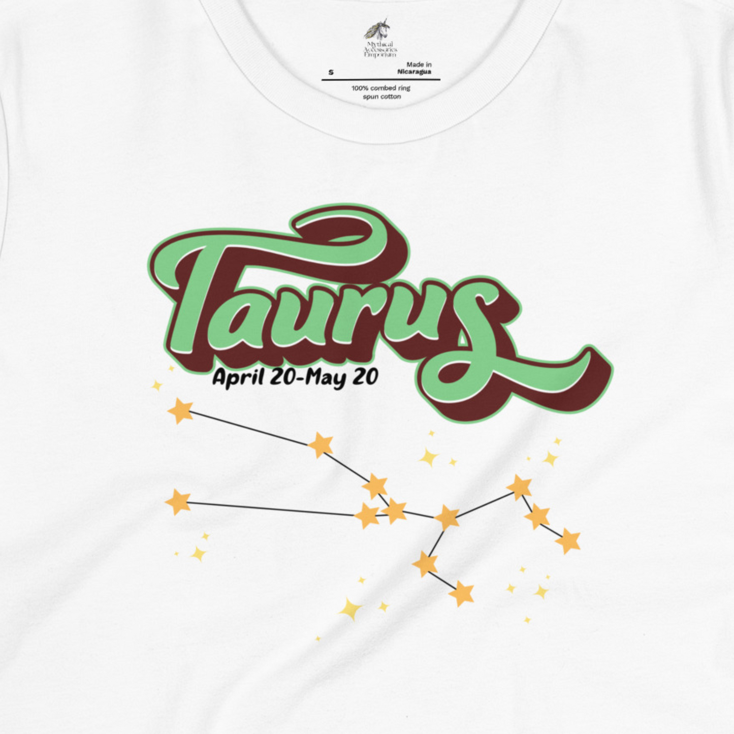 Up close Front view of white Taurus Tee. This Astrology T-Shirt has the word Taurus in large leaf green script shadowed in deep brown for a 3-D effect. Below this it Says April 20-May 20. At the bottom is the star constellation for Taurus with yellow stars connected by a black line and smaller stars surrounding the constellation. The perfect April or May Birthday Gift for Her or yourself.
