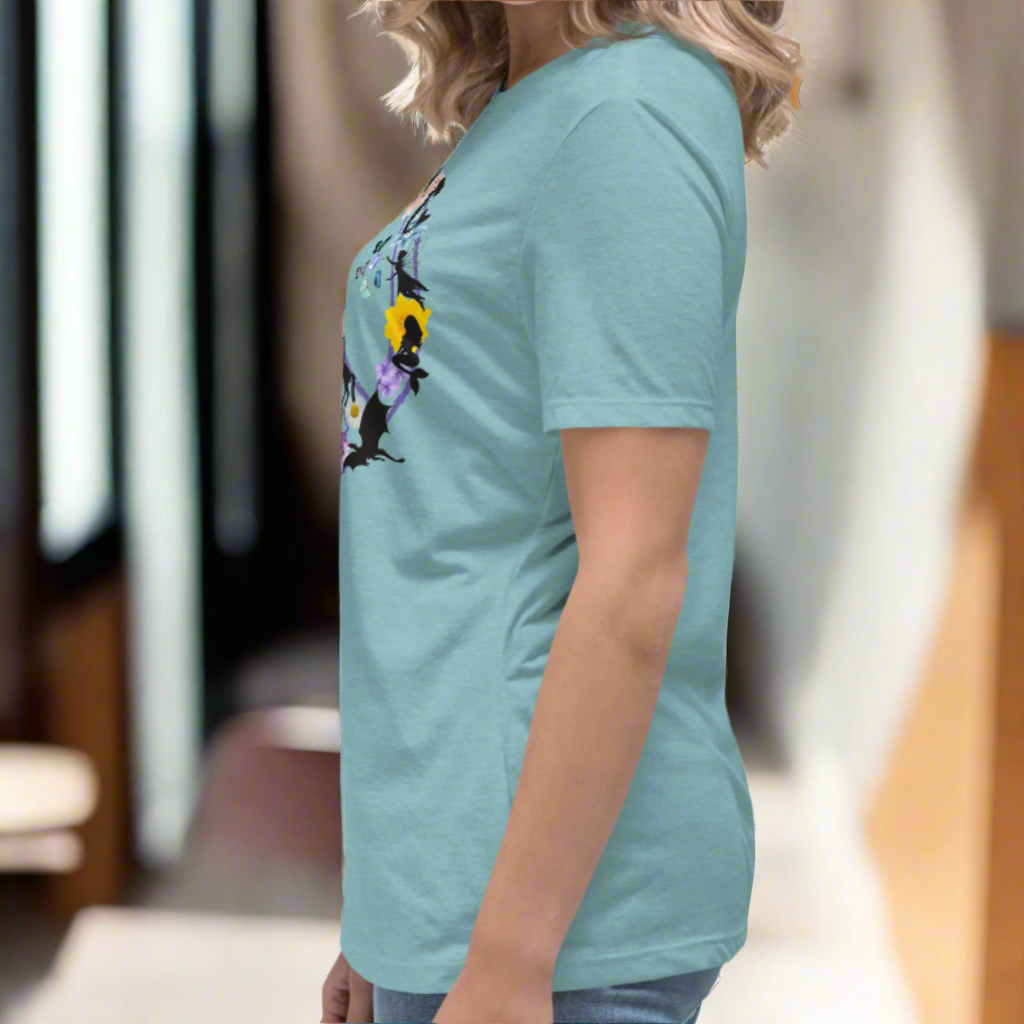70s Vintage Peace Sign Women's heather blue lagoon T-Shirt left side View. Purple Peace sign filled in with dragons, mermaids, fairies, unicorns, pegasi, witches, flowers, and butterflies.