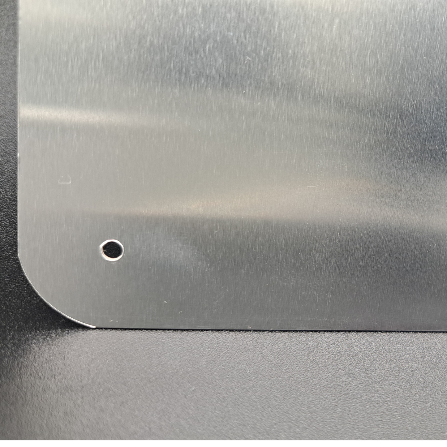 This is a look at the back of the sign at the bottom left corner. You can see the rounded edge and the hole that is in each corner to allow hanging of the sign.