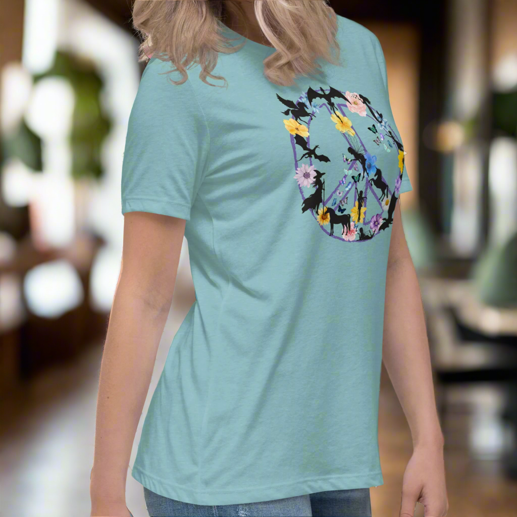 70s Vintage Peace Sign Women's heather blue lagoon T-Shirt side View. Purple Peace sign filled in with dragons, mermaids, fairies, unicorns, pegasi, witches, flowers, and butterflies.