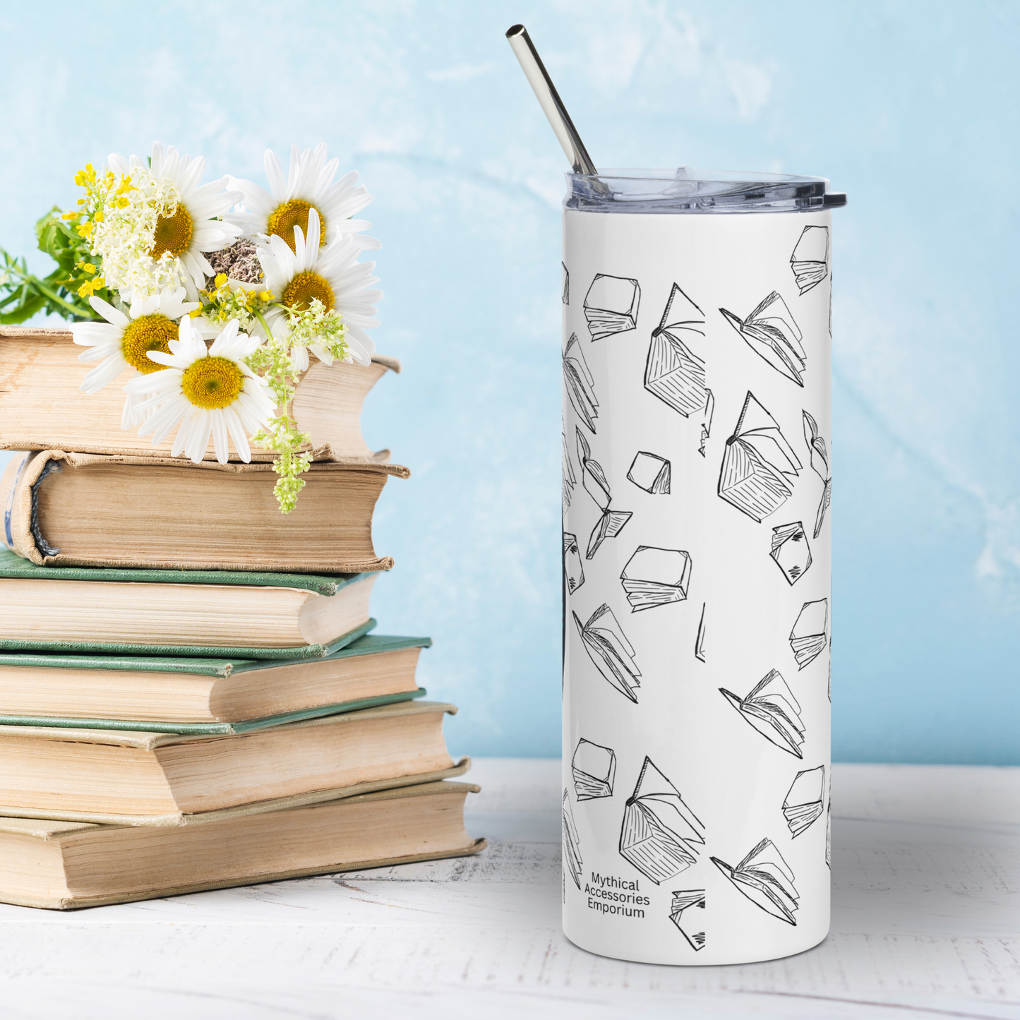 Back view Book Dragon Graphic on White stainless steel 20 oz tumbler. You see the background of black outlines of books surrounding the entire tumbler. You see the metal straw sticking out of the top. Bookish Gift for Fantasy Lovers