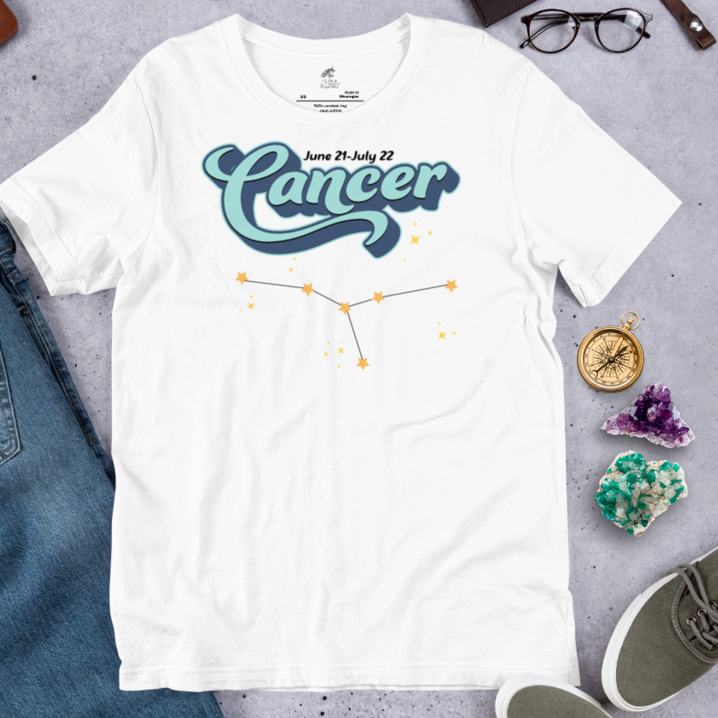 Front view of flat shirt white men's Cancer Tee. This astrology Cancer T-Shirt has the word Cancer in large light blue script shadowed in deep blue for a 3-D effect. Above this it Says June 21-July 22. Under Cancer is the zodiac star constellation with yellow stars connected by a black line and lighter yellow smaller stars surrounding this. The perfect June or July Birthday Gift for him or yourself.