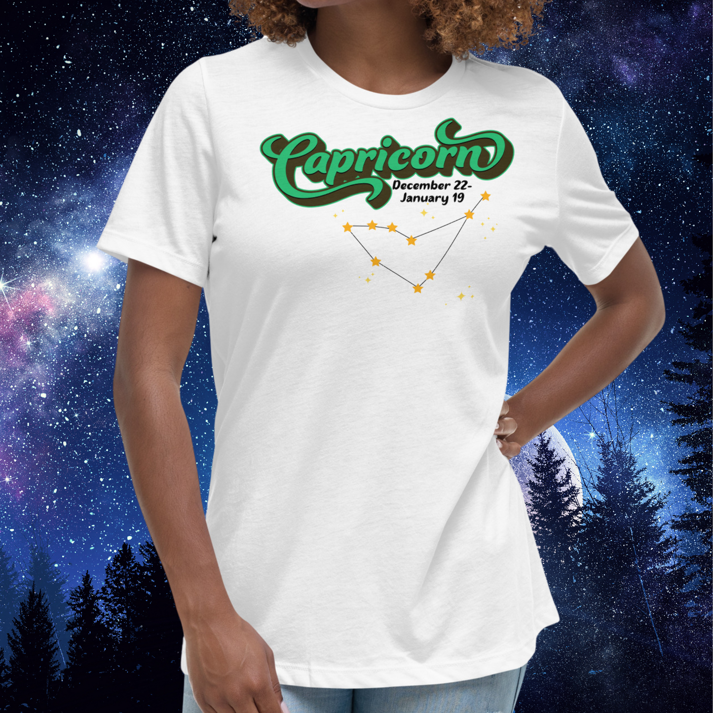 Front view of model wearing white women's Capricorn Tee. This astrology T-Shirt has the word Capricorn in a large green script shadowed in black for a 3-D effect. Below this it Says December 22-January 19. Under Capricorn is the zodiac star constellation with yellow stars connected by a black line and lighter yellow smaller stars surrounding this. The perfect December or January Birthday Gift for Her or yourself.