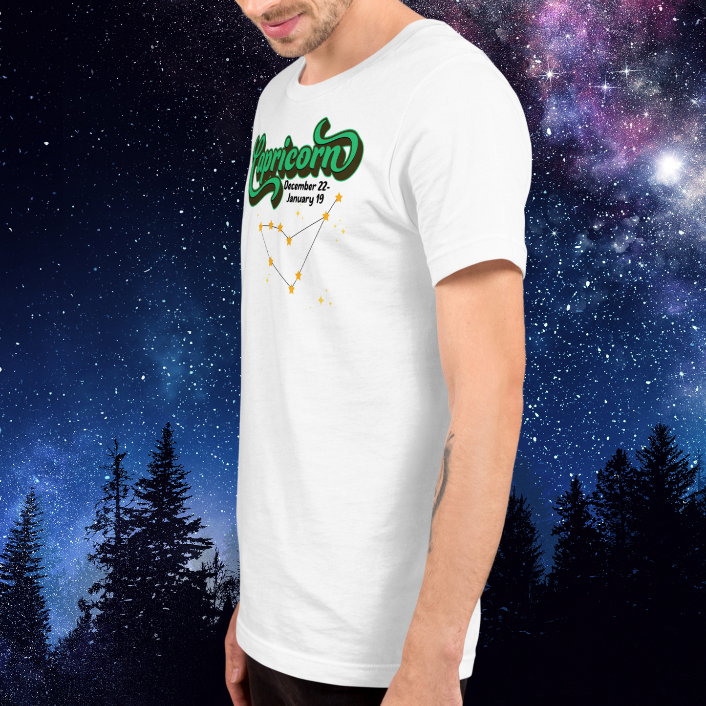 Left side view of model wearing white men's Capricorn Tee. This astrology T-Shirt has the word Capricorn in large bright green script shadowed in deep brown almost black for a 3-D effect. Below this it Says December 22-January 19. Under Capricorn is the zodiac star constellation with yellow stars connected by a black line and lighter yellow smaller stars surrounding this. The perfect December or January Birthday Gift for him or yourself.