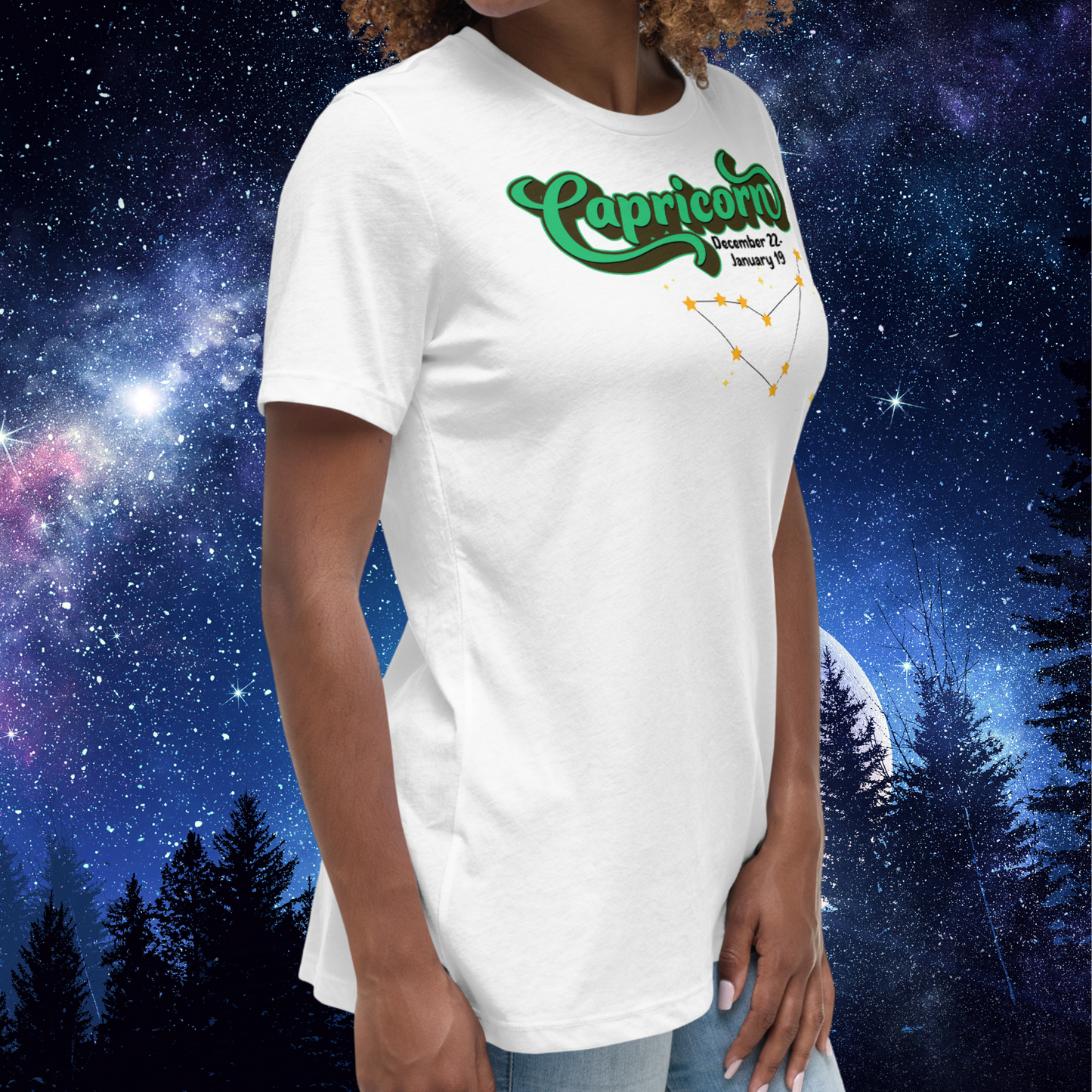 Right side view of model wearing white women's Capricorn Tee. This astrology T-Shirt has the word Capricorn in a large green script shadowed in black for a 3-D effect. Below this it Says December 22-January 19. Under Capricorn is the zodiac star constellation with yellow stars connected by a black line and lighter yellow smaller stars surrounding this. The perfect December or January Birthday Gift for Her or yourself.