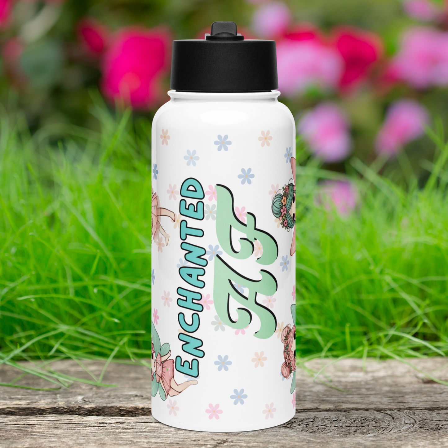 Enchanted AF Fairy Tumbler Front View with Black Lid. Enchanted is in blue text with a black outline. AF is a light pistachio green with black drop shadow. You can see the tops and bottoms of fairies to the left and right. Background is pastel daisies.