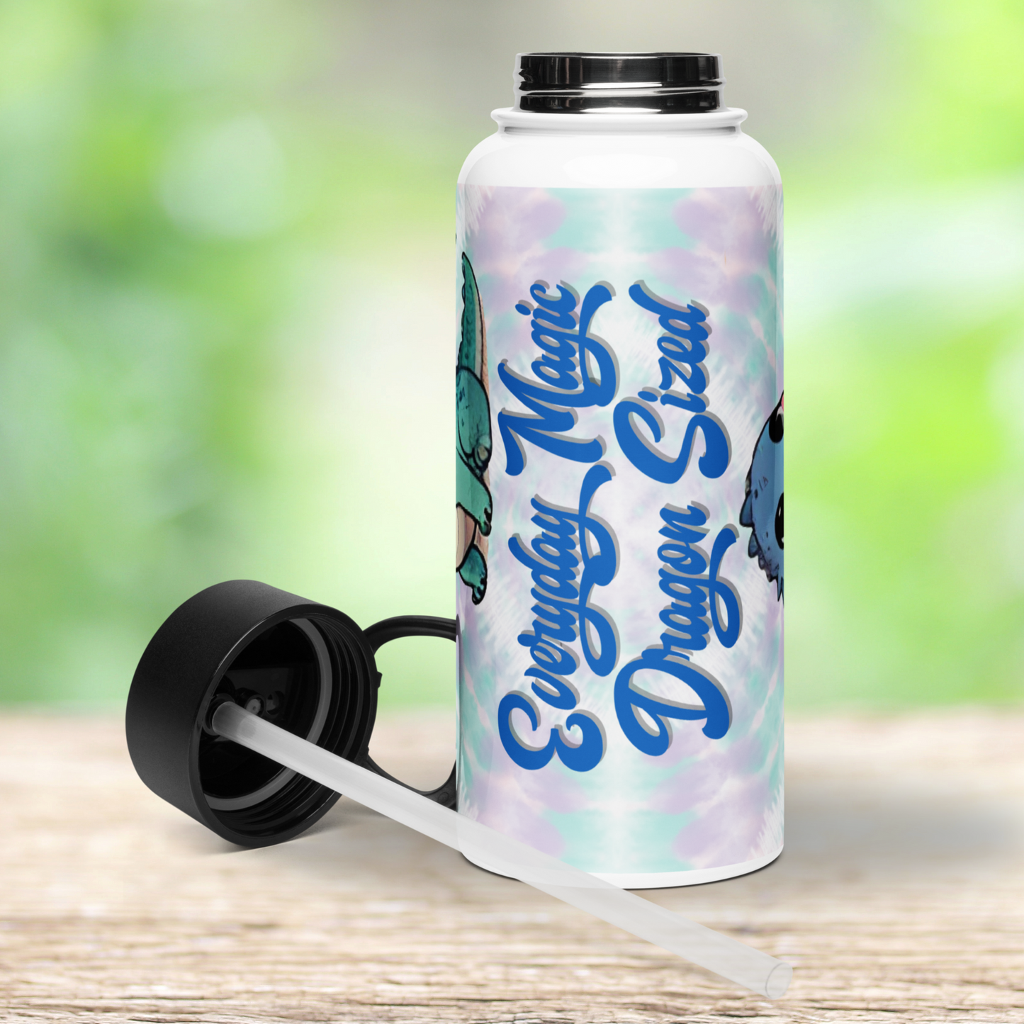 Front view of stainless steel dragon tumbler with lid off and on the left side of the bottle. You can see the silver of the top of the bottle where the lid screws on. The lid is black and you can see the plastic straw attached to the bottom.