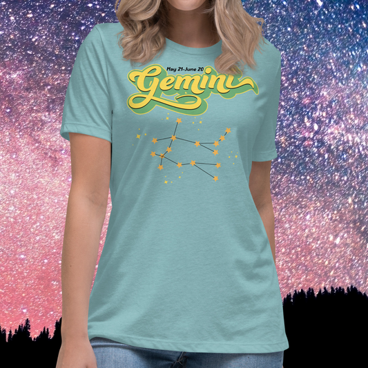 Front view of model wearing heather blue lagoon women's Gemini Tee. This Astrology T-Shirt has the word Gemini in large lemon yellow script shadowed in bright green for a 3-D effect. Above this it Says May 21-June 20. Under Gemini is the star constellation with yellow stars connected by a black line and yellow smaller stars surrounding this. The perfect May or June Birthday Gift for Her or yourself.