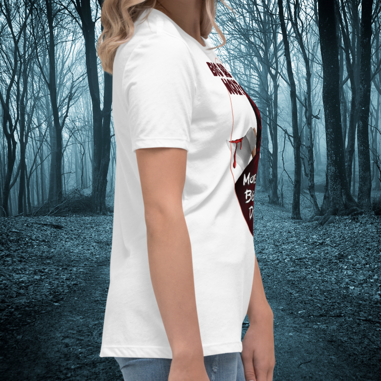 Red Riding Hood Women's Dark Fantasy T-Shirt. Right side View White Graphic Tee on Model. Oval frame with thin red border is visible. The axe head with dripping blood and some of the text can be seen. Short white sleeves and crew neck collar.