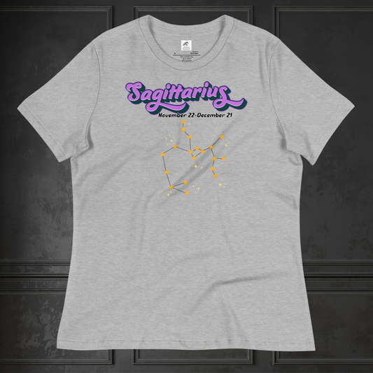 Front view of flat athletic heather (grey) women's Sagittarius Tee. This astrology T-Shirt has the word Sagittarius in large purple script shadowed in black for a 3-D effect. Below this it Says November 22-December 21. Under Sagittarius is the zodiac star constellation with yellow stars connected by a black line and lighter yellow smaller stars surrounding this. The perfect November or December Birthday Gift for her or yourself.