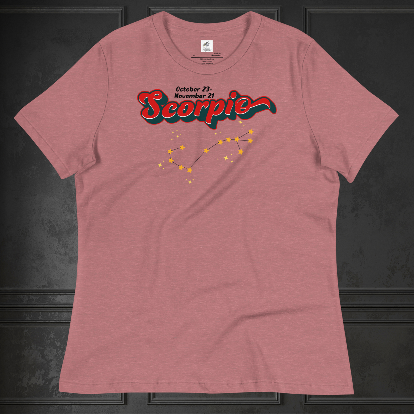 Front view of flat heather red women's Scorpio Tee. This astrology Scorpio T-Shirt has the word Scorpio in large red script shadowed in deep dark blue for a 3-D effect. Above this it Says October 23-November 21st. Under Scorpio is the zodiac star constellation with yellow stars connected by a black line and lighter yellow smaller stars surrounding this. The perfect October or November Birthday Gift for her or yourself.
