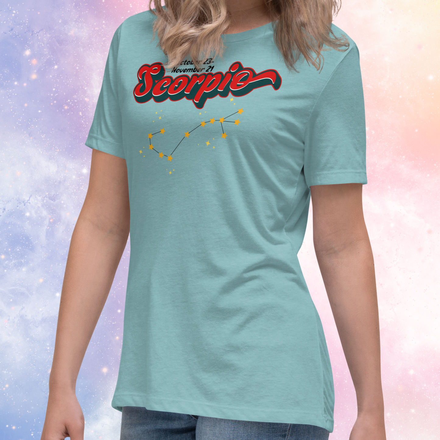 Front left view of model wearing Heather blue lagoon women's Scorpio Tee. This astrology Scorpio T-Shirt has the word Scorpio in large red script shadowed in deep dark blue for a 3-D effect. Above this it Says October 23-November 21st. Under Scorpio is the zodiac star constellation with yellow stars connected by a black line and lighter yellow smaller stars surrounding this. The perfect October or November Birthday Gift for her or yourself.