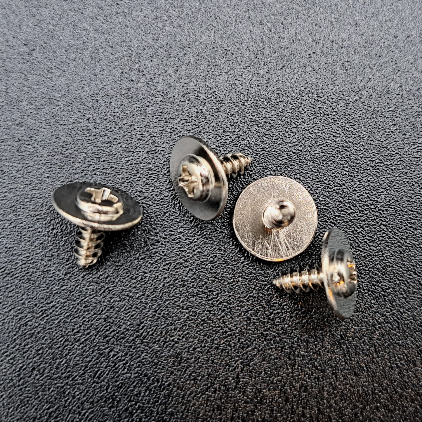 In this photo you see the 4 screws and metal washers that are included to hang the metal sign.