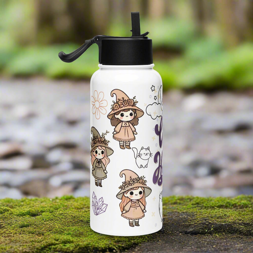 Left side of white water bottle with black lid. Straw is flipped up and adjustable handle is sticking out to the side. 3 adorable witches with flowers around their hats. You can see the outline of a cat, flower, and crystals.
