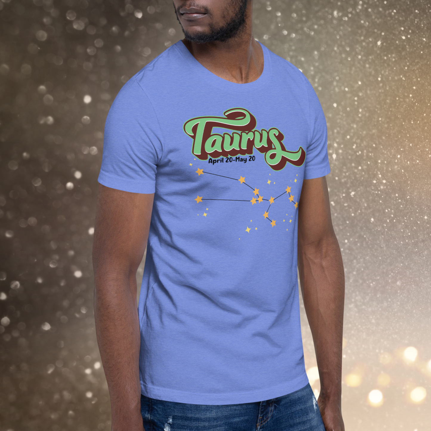 Front right view of model wearing heather Columbia blue men's Taurus Tee. This Astrology T-Shirt has the word Taurus in large leaf green script shadowed in deep brown for a 3-D effect. Below this it Says April 20-May 20. At the bottom is the star constellation for Taurus with yellow stars connected by a black line and smaller stars surrounding the constellation. The perfect April or May Birthday Gift for him or yourself.