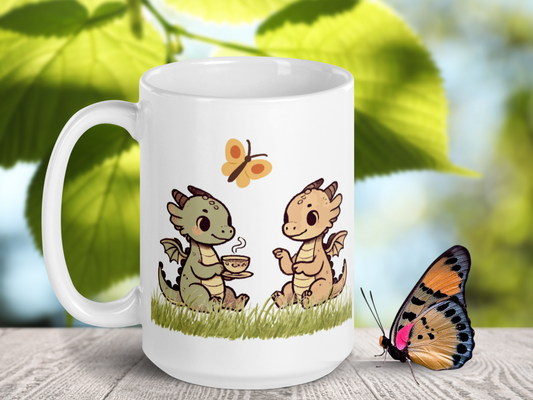 White  dragon tea mug with the handle to the left. On the left is a light green dragon sitting in the grass with a steaming mug of tea. On the right is a light red or pink dragon sitting in the grass. Above the dragons is a yellow butterfly.