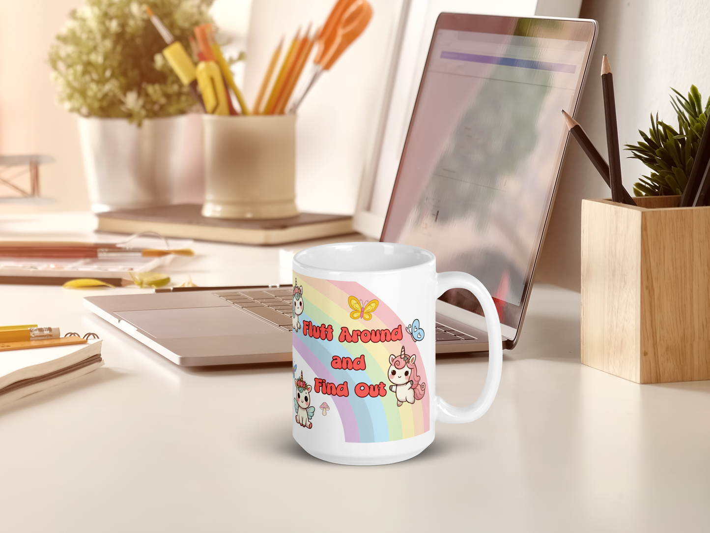 Mythical Unicorn Pegasus Rainbow ceramic 15 oz white mug with handle to the right. Mug is sitting on a computer desk next to a laptop computer.
