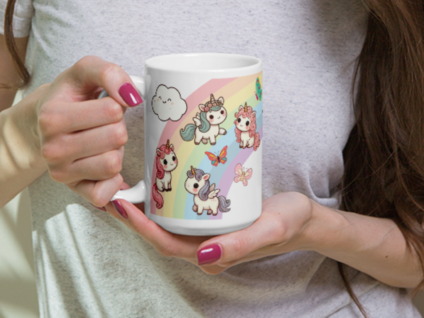 Unique Gift Unicorn Pegasus Rainbow ceramic 15 oz white mug with handle to the left. Mug is being held by a woman for size comparison.