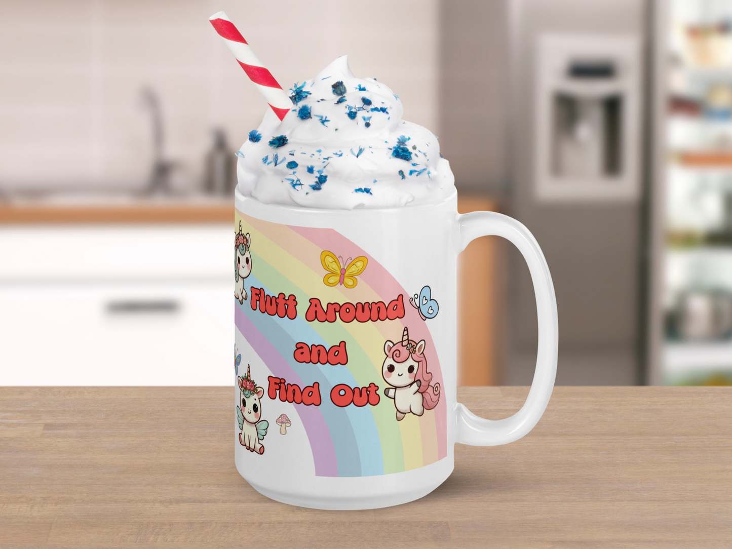 Sarcastic Unicorn Pegasus Rainbow ceramic 15 oz white mug with handle to the right. Mug is sitting on a kitchen counter. You can see the mug is filled with whipped cream and red and white straw. Rainbow, unicorn, unicorn pegasus are visible with text "Fluff Around and Find Out".