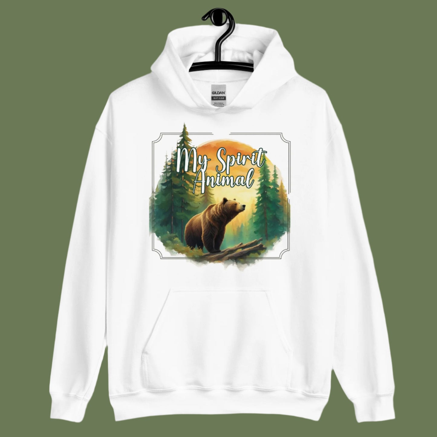 My Spirit Animal bear women's hoodie. Front view on hanger white hoodie. Grizzly Bear paused in front of logs walking through the forest framed in a sunset. My Spirit Animal text at the top in white script.