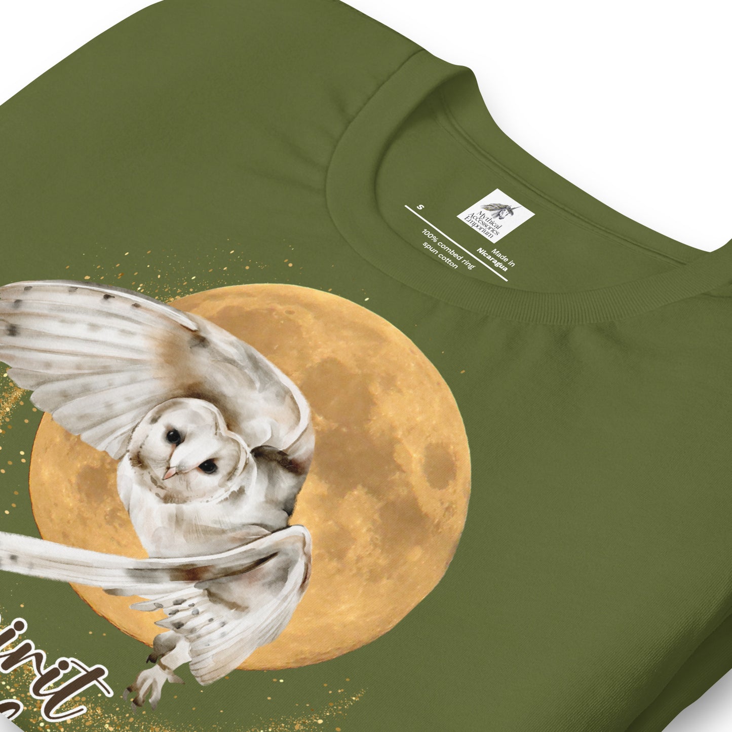 My spirit animal owl men's graphic tee, olive shirt folded front view, white owl flying against a harvest moon wings sparking a gold magical halo, mythical accessories emporium