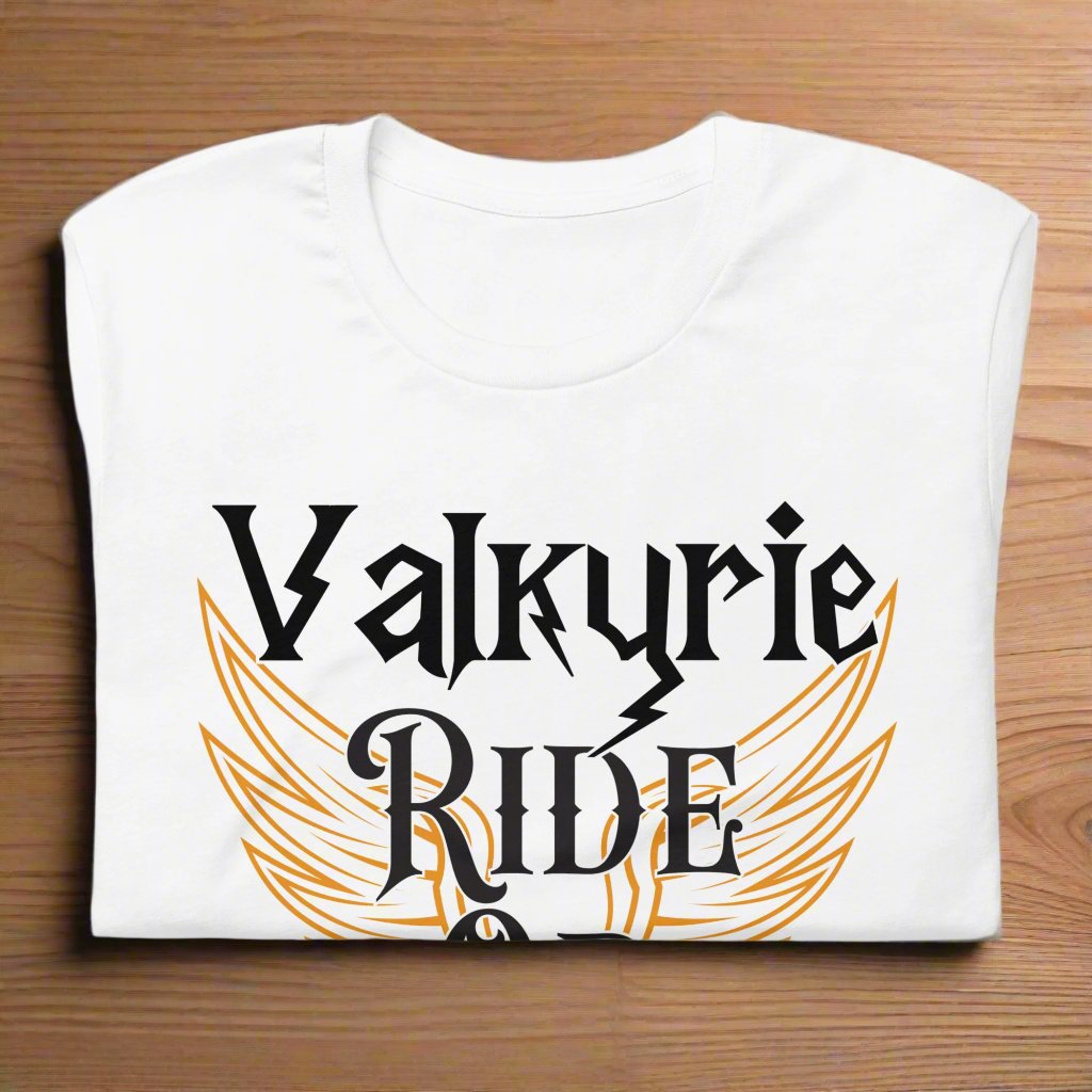 white Front View Valkyrie Ride or Die, Men's Tshirt folded on counter. White wings edged in gold spread to either side of the shirt. Through the middle is the black text edged in white. Text reads Valkyrie Ride or Die