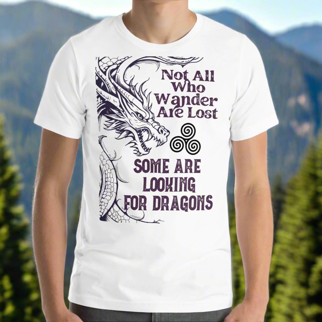 white men’s T-shirt, front view. Right side features a dragon in smoky gray-purple with the Celtic triskele symbol emerging from its nostrils. Text above reads "Not All Who Wander Are Lost," with "Some Are Looking for Dragons" below.