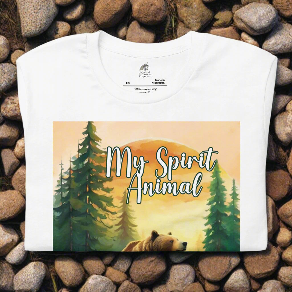 Men's My Spirit Animal Grizzly Bear T-Shirt. Front folded on rock path view white. Grizzly Bear paused in front of logs walking through the forest framed in a sunset. My Spirit Animal text at the top in white script.