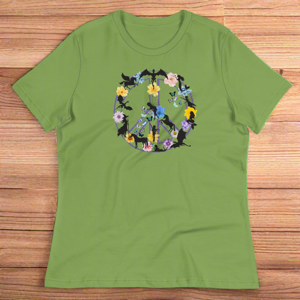 70s Vintage Peace Sign Women's leaf (green) T-Shirt Front View laying on wooden counter. Purple Peace sign filled in with dragons, mermaids, fairies, unicorns, pegasi, witches, flowers, and butterflies.