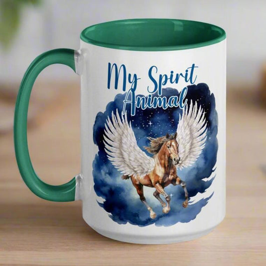 My Spirit Animal Pegasus Coffee Mug, white ceramic mug with handle on left green interior and handle, Pegasus white feathered wings on a Pinto with a dark brown mane and tail, galloping against a background of clouds and stars. Mythical Accessories