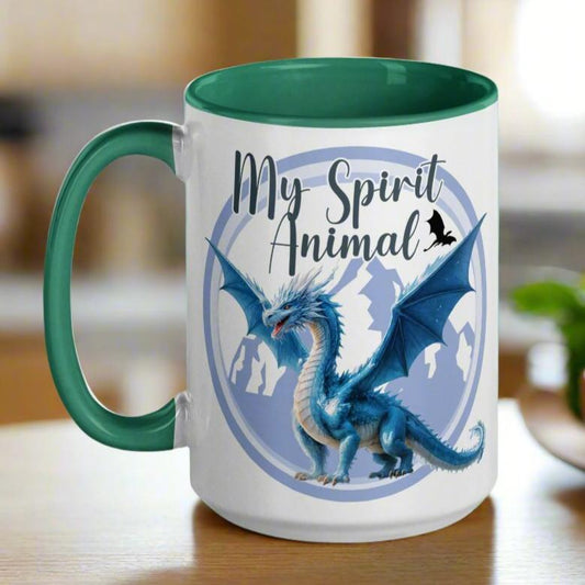 My Spirit Animal Dragon Ceramic Coffee Mug, white mug with green interior and handle, handle to right, Blue Ice Dragon with wings spread standing in front of snow capped mountain range with a dragon silhouette flying above within a blue grey circle