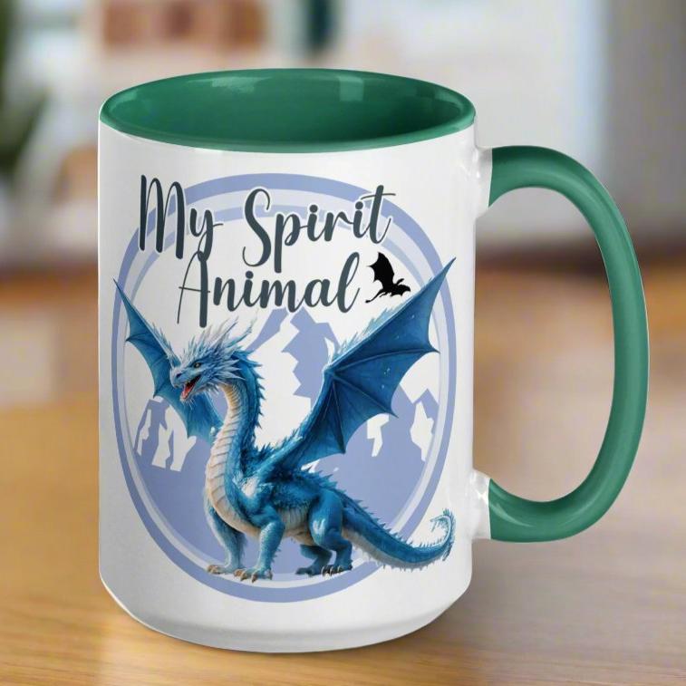 My Spirit Animal Dragon Ceramic Coffee Mug, white mug with green interior and handle, handle to right, Blue Ice Dragon with wings spread standing in front of snow capped mountain range with a dragon silhouette flying above within a blue grey circle