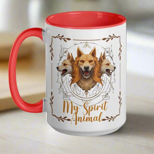 Mug, handle to the left, interior and handle red. A three headed guardian of the underworld in golden browns, each head facing a different direction. Design centered on mythic symbols framed in branches. Under Cerberus text in gold says My Spirit Animal